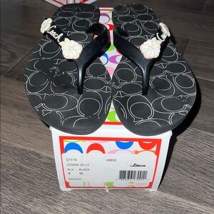 Coach Black Flip Flops with White Floral Design